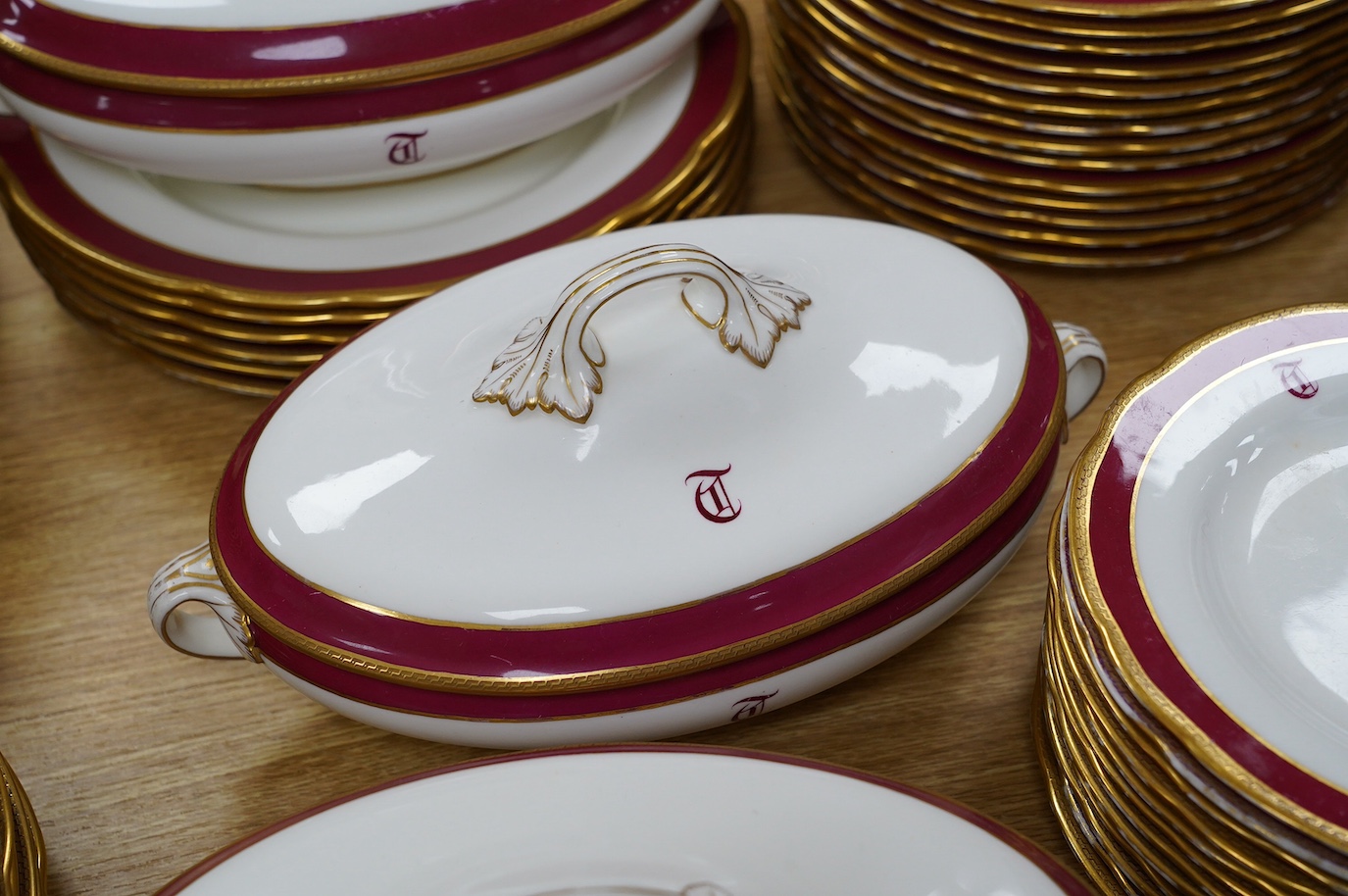 An extensive T. Goode & Co. Wedgwood red and gilt bordered dinner service, monogrammed 